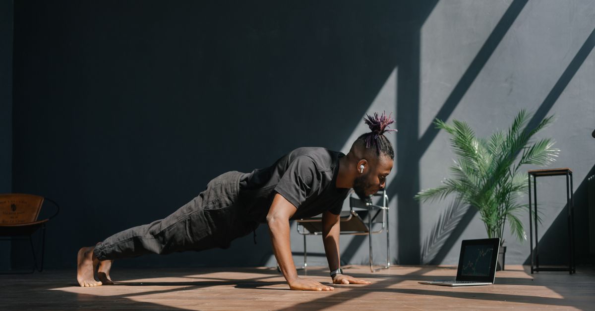 person laughing while doing one push-up in bedroom
