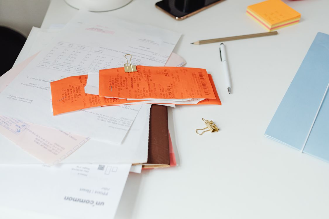 Organized receipts and documents on a desk representing streamlined order management workflow