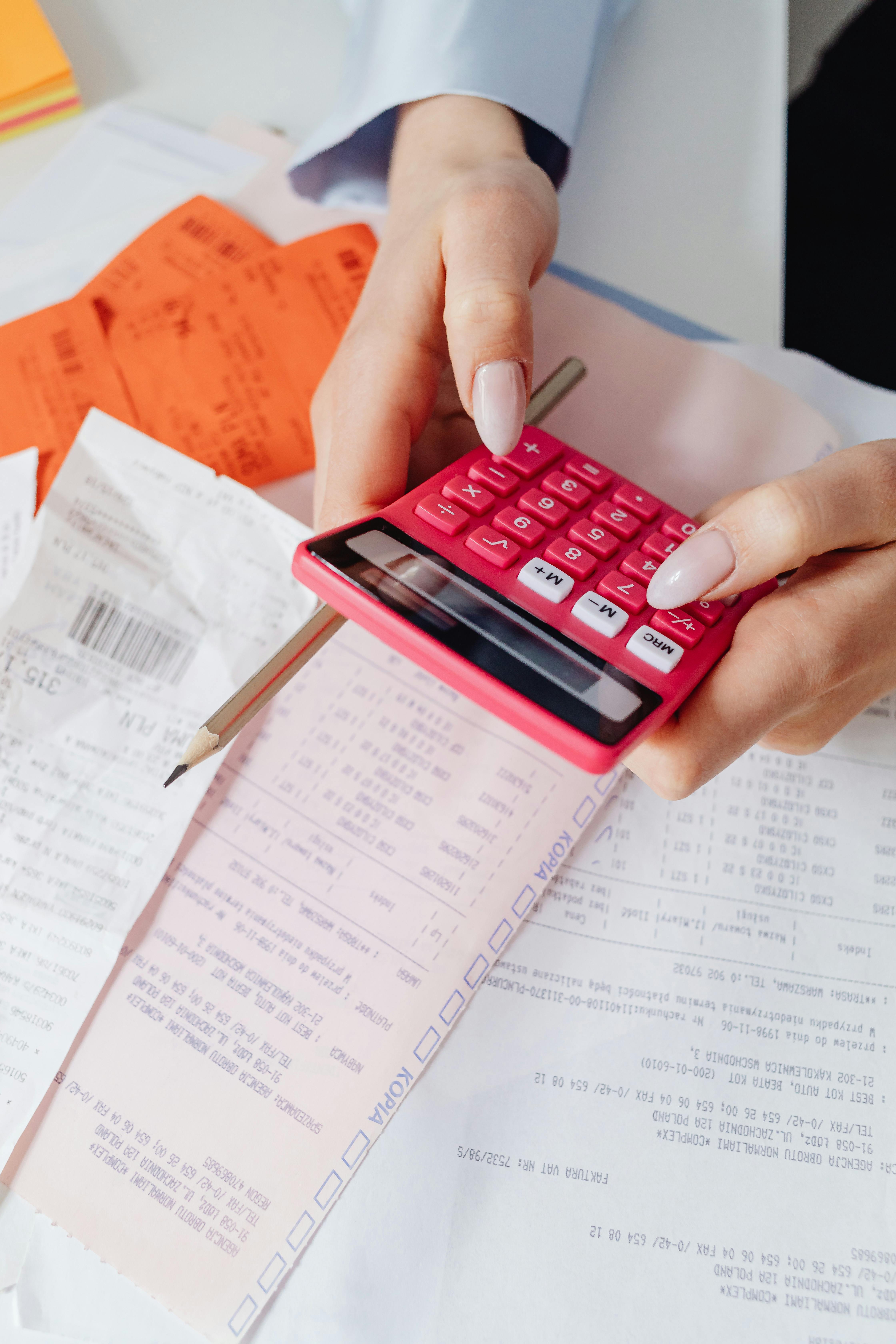 close up shot of a person holding a calculator