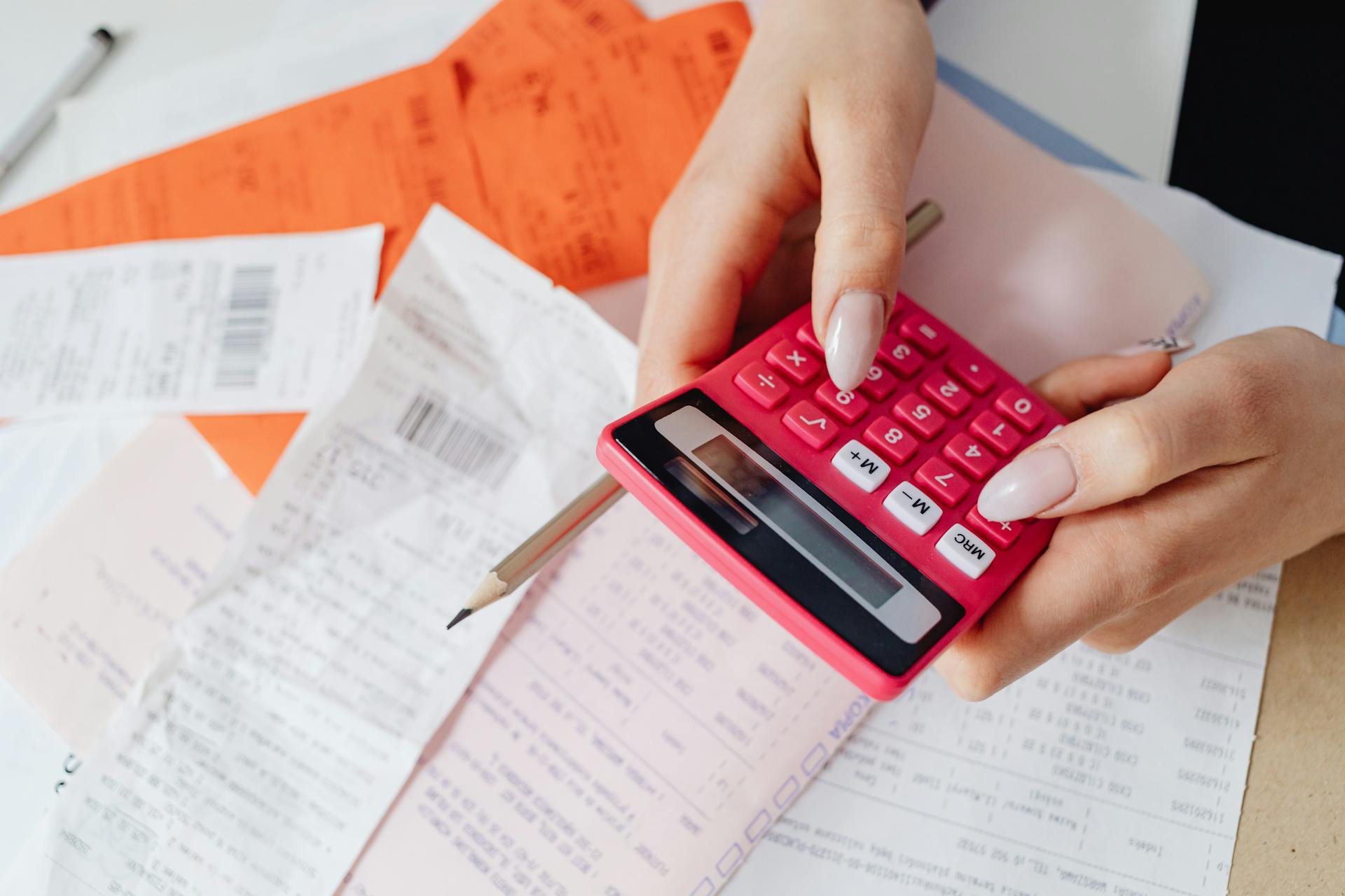 A Close-Up Shot of a Person Using a Calculator