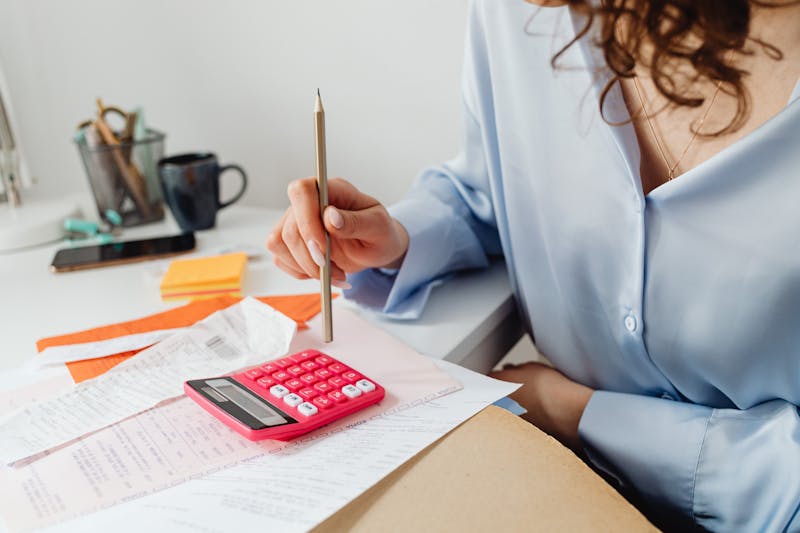 Professional calculating expenses at a clean, organised desk