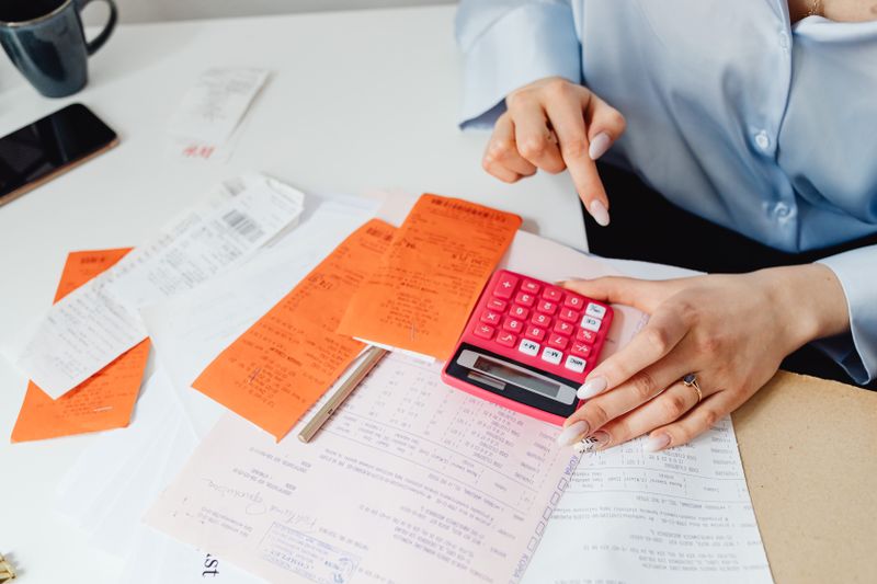 Accountant reviewing financial cost calculations on a desk