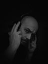 Grayscale Photo of Woman Covering Her Face With Her Hand