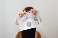 A Person Tearing Apart a Piece of Paper