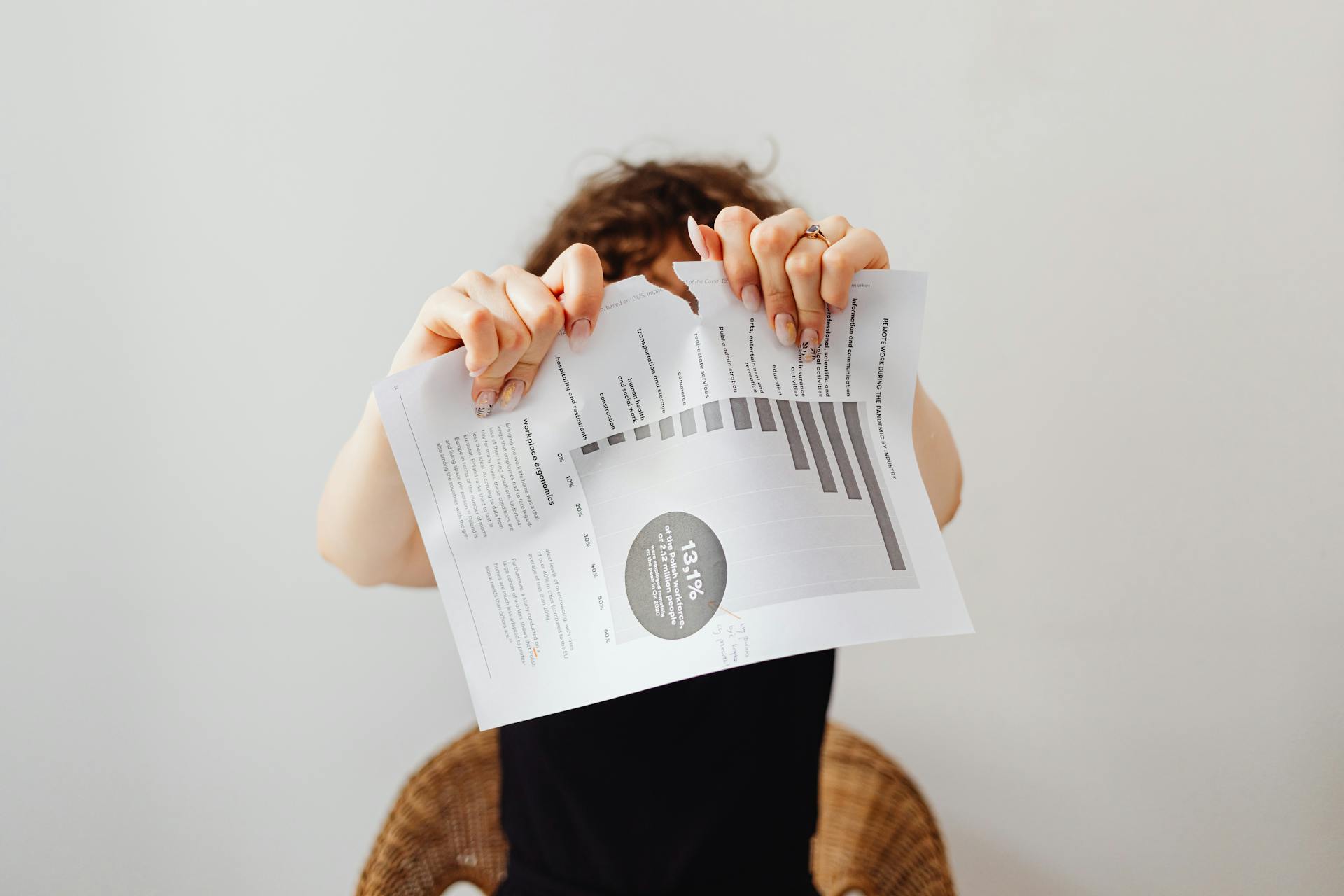 A Person Tearing Apart a Piece of Paper
