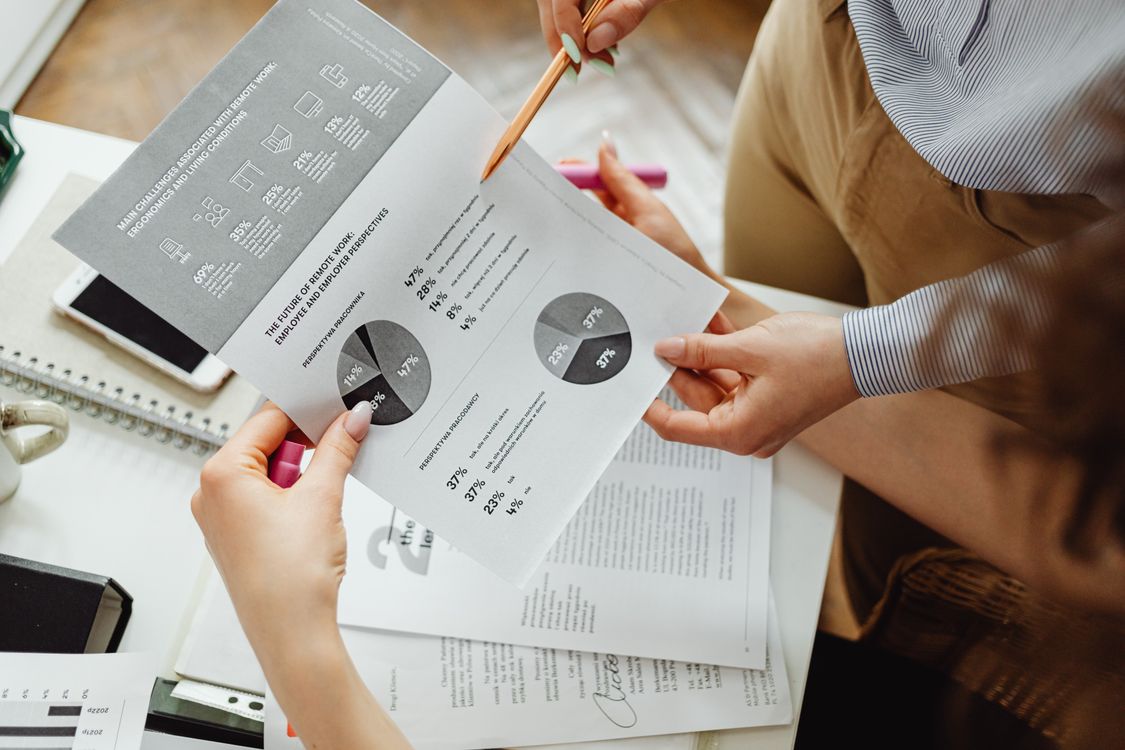 Professionals reviewing financial reports and charts for accurate disclosures
