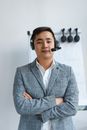 Confident Man in Gray Suit Jacket Wearing His Headphones