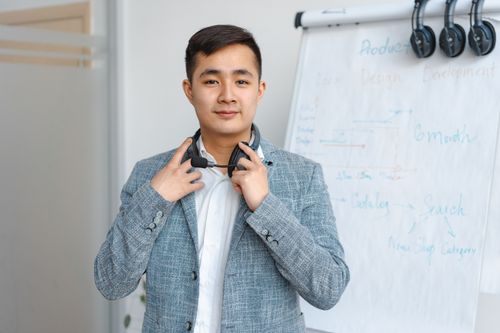 Free Portrait of a young man with a headset in a modern office environment. Stock Photo