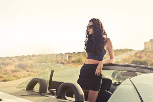 Woman Standing Leaning at Convertible Car