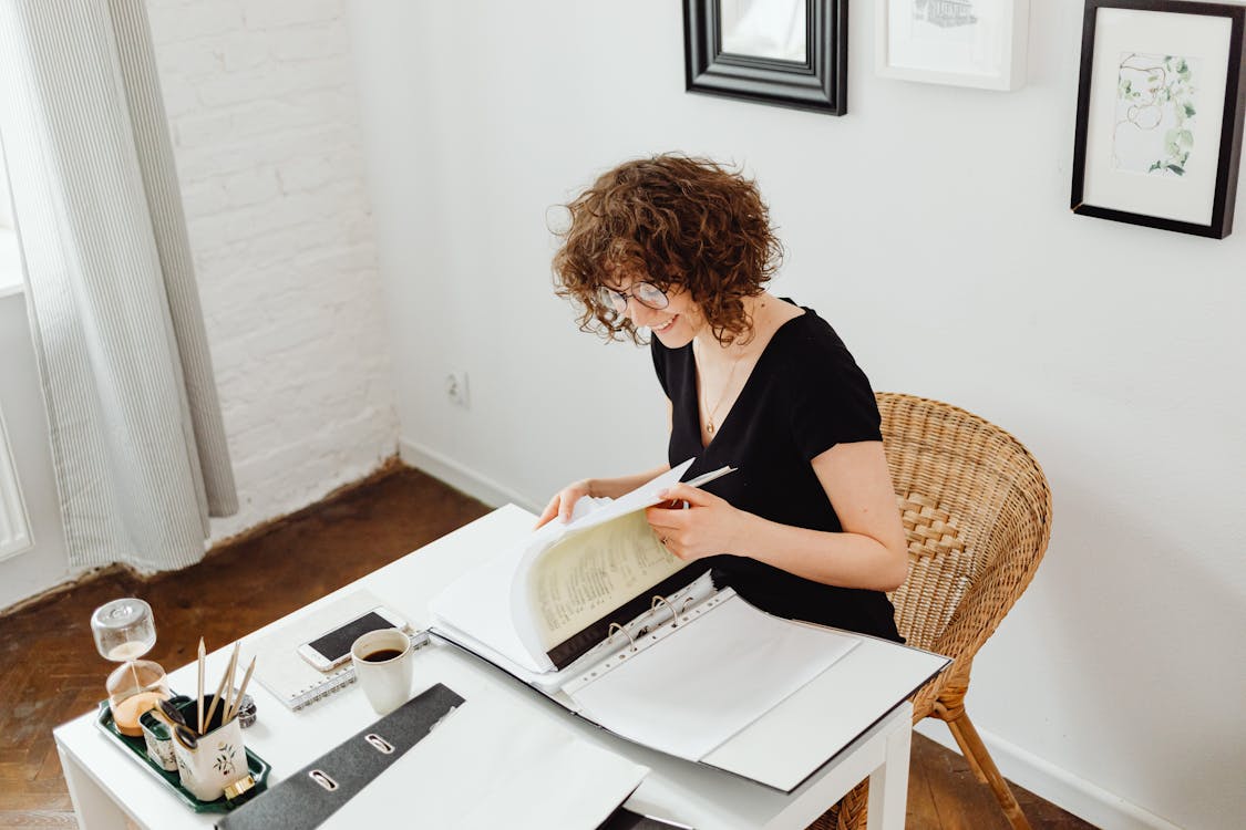 Free Smiling Woman Doing Her Paperwork Stock Photo