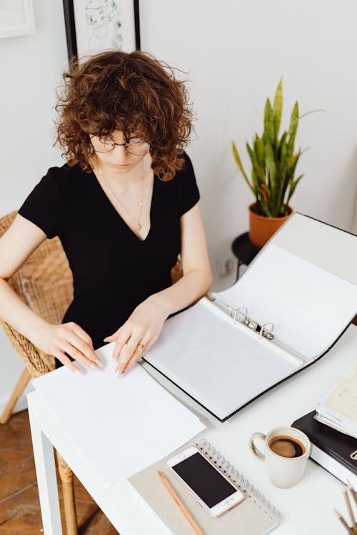 Free Woman in Black V-Neck Shirt Doing Her Paperwork Stock Photo
