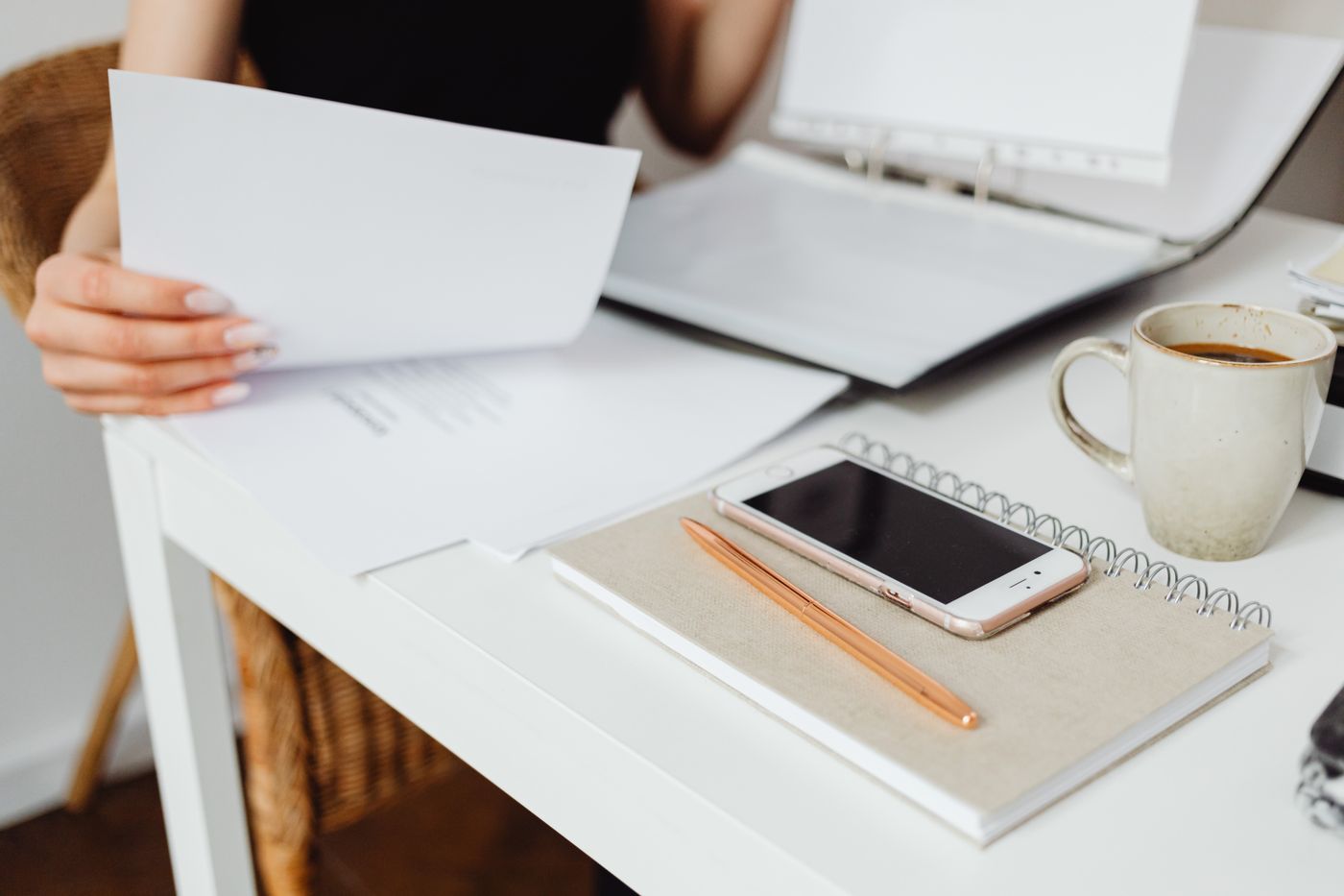 Estimator's desk with a stack of paper quotes and a ringing phone