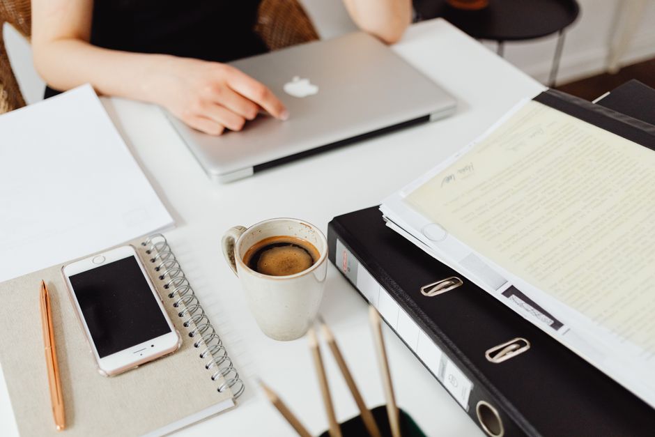 reviewing the first work tasks before opening distractions coffee mug notebook task list lifestyle photo 1