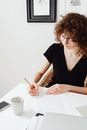 Woman in Black Shirt Writing on White Paper