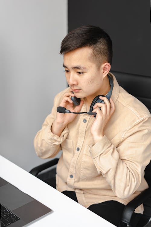 Photo of an Operator Holding Black Headphones