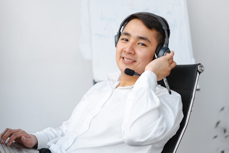 Man In White Long Sleeves Wearing A Headset