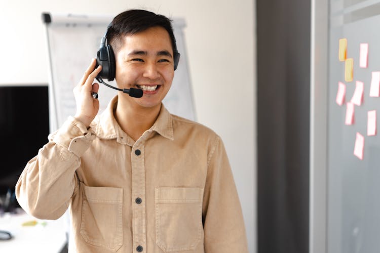 Man In Brown Long Sleeve Shirt Wearing Headset