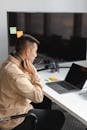 Man in Brown Jacket Using Black and Gray Laptop Computer