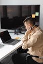 Man in Brown Jacket Using Laptop Computer