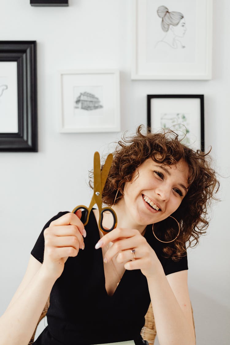 Curly-Haired Woman Holding Scissors