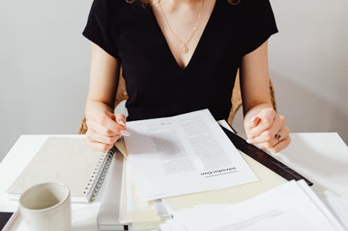 Free Woman Sitting Beside the Documents Stock Photo