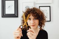 Woman in Black Shirt Holding Black and Gold Padlock