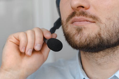 Free Close Up Photo of a Man Holding a Headphone Stock Photo