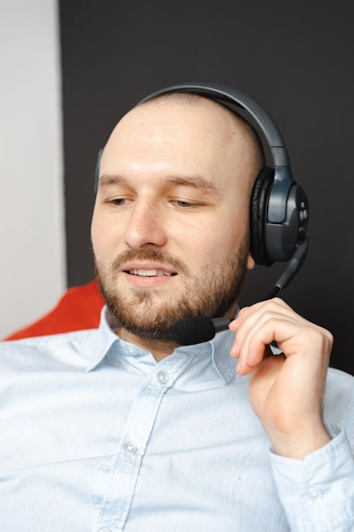 Free Man in White Button Up Shirt Wearing Black Headphones Stock Photo