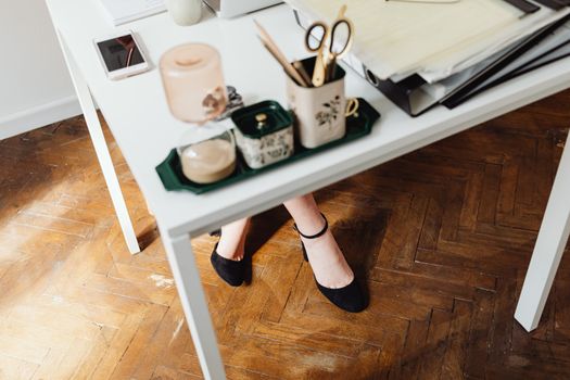 Woman Legs under Table