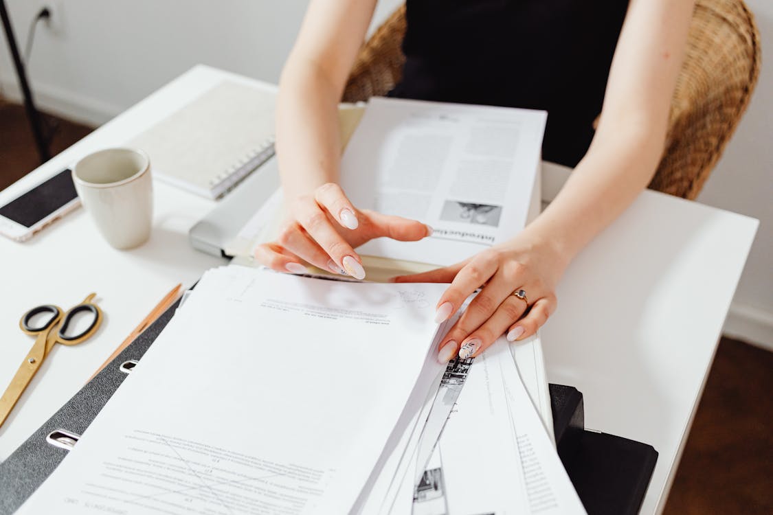 Free Close-Up Photo of Person Doing Paperwork Stock Photo