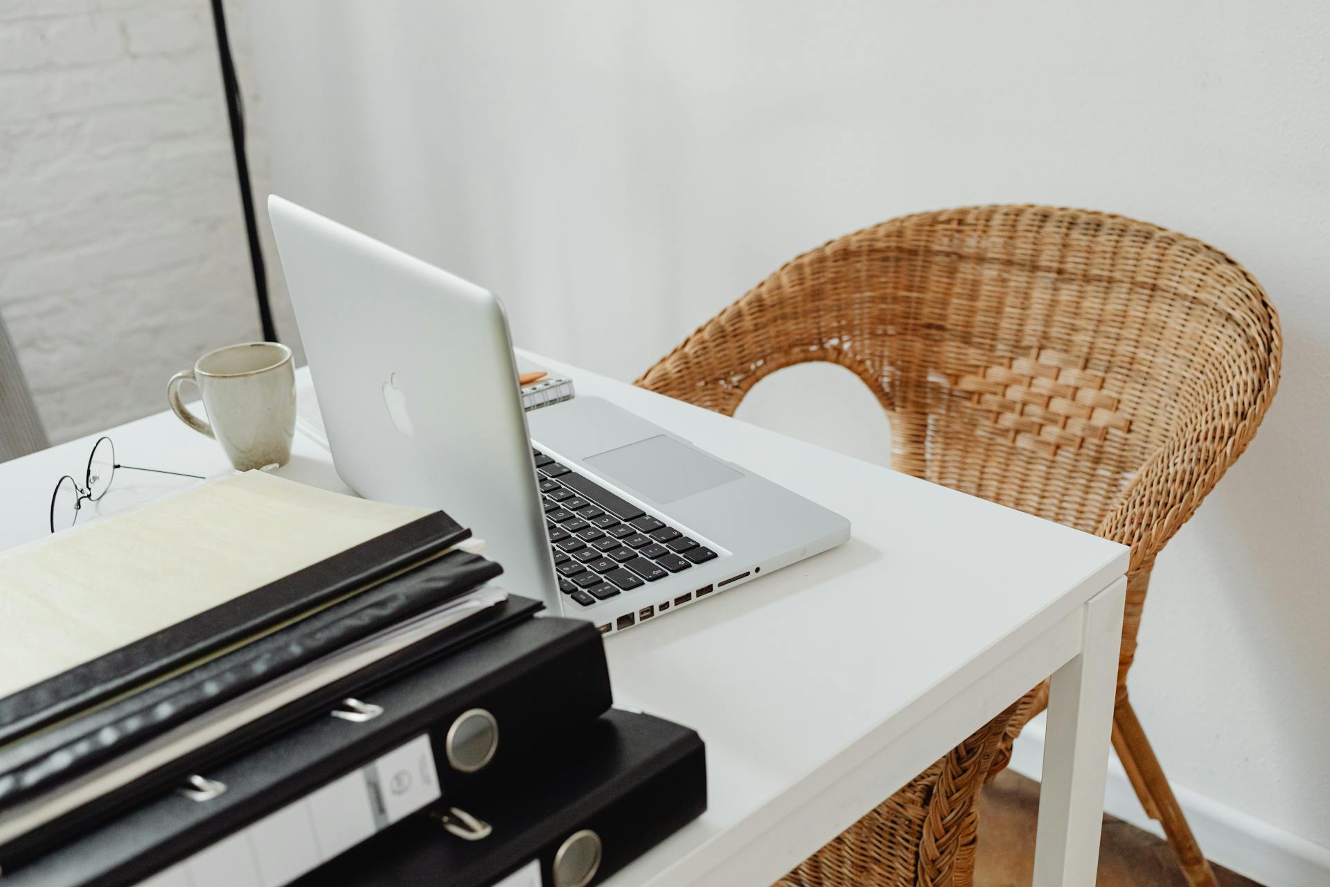 A Table with Documents and a Laptop