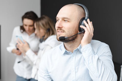 Man in Blue Long Sleeves Wearing Headphones