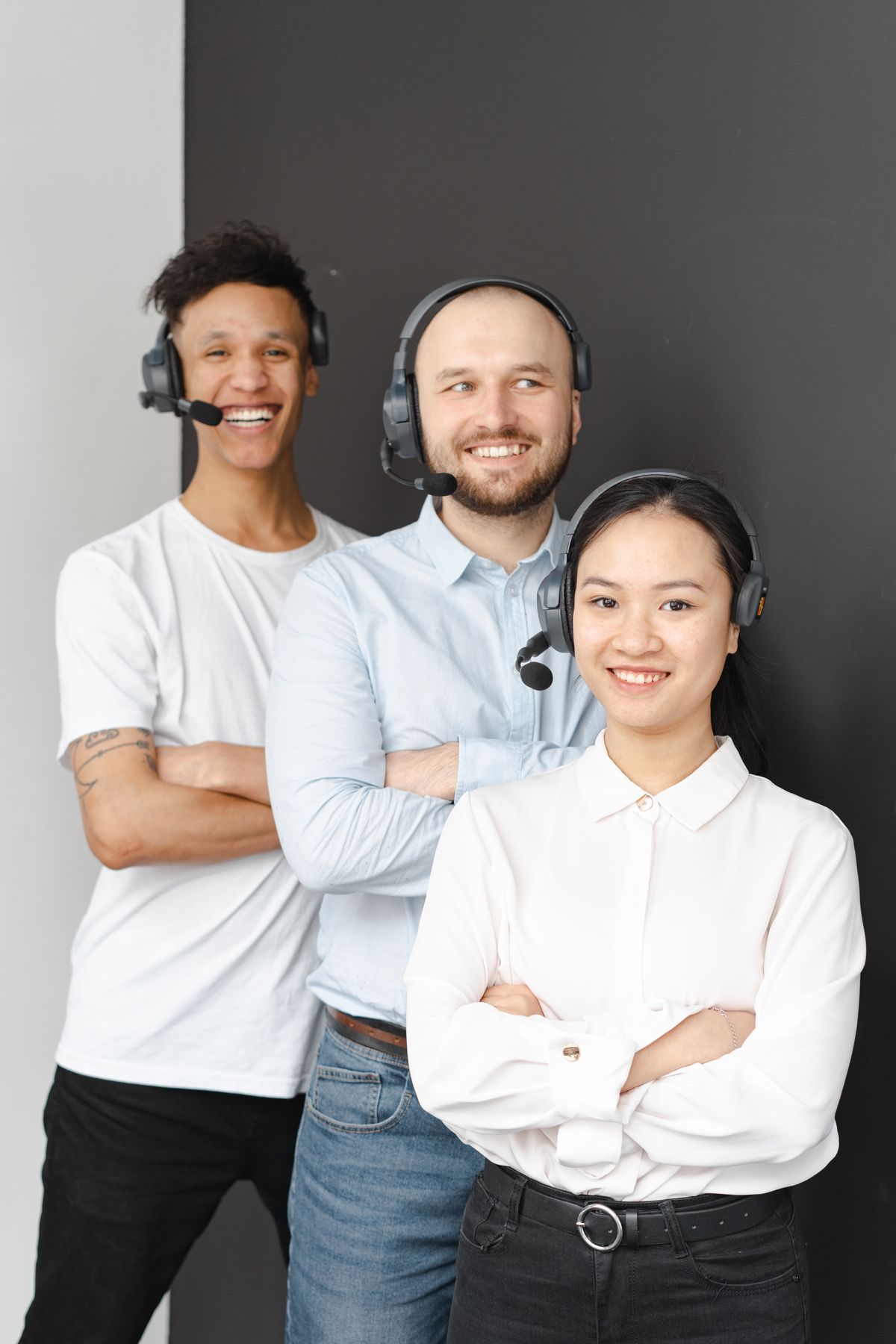 Smiling support specialists with headsets helping Salesforce users in an office