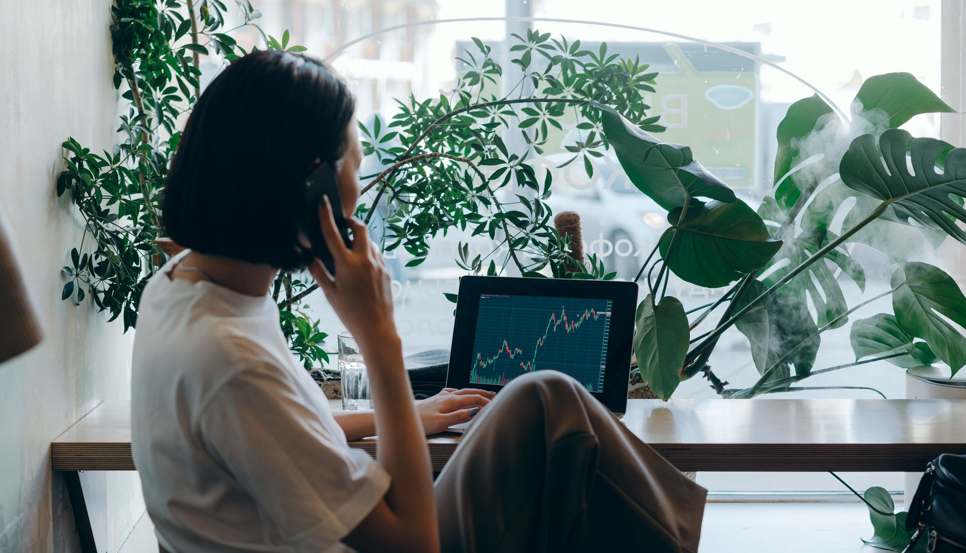 A finance professional reviewing charts on a laptop during a call