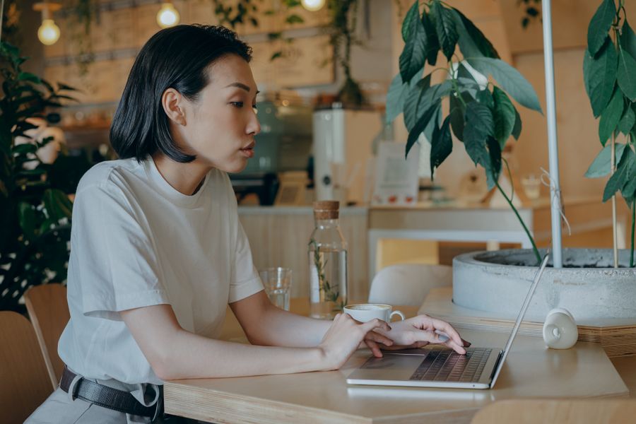 Business owner working on a laptop in a cafe