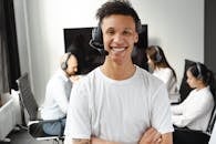 Man in White Crew Neck T-shirt Wearing Black Headphones