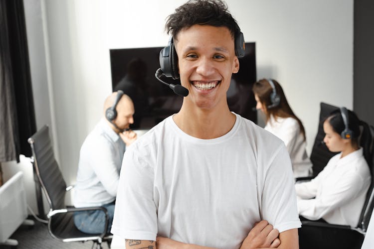 Man Smiling While Wearing A Headset