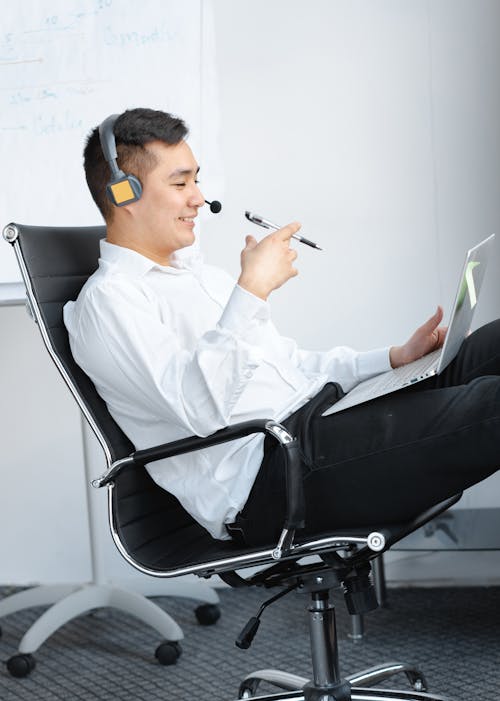 Free Photo of a Man with a Headset Sitting on a Chair Stock Photo