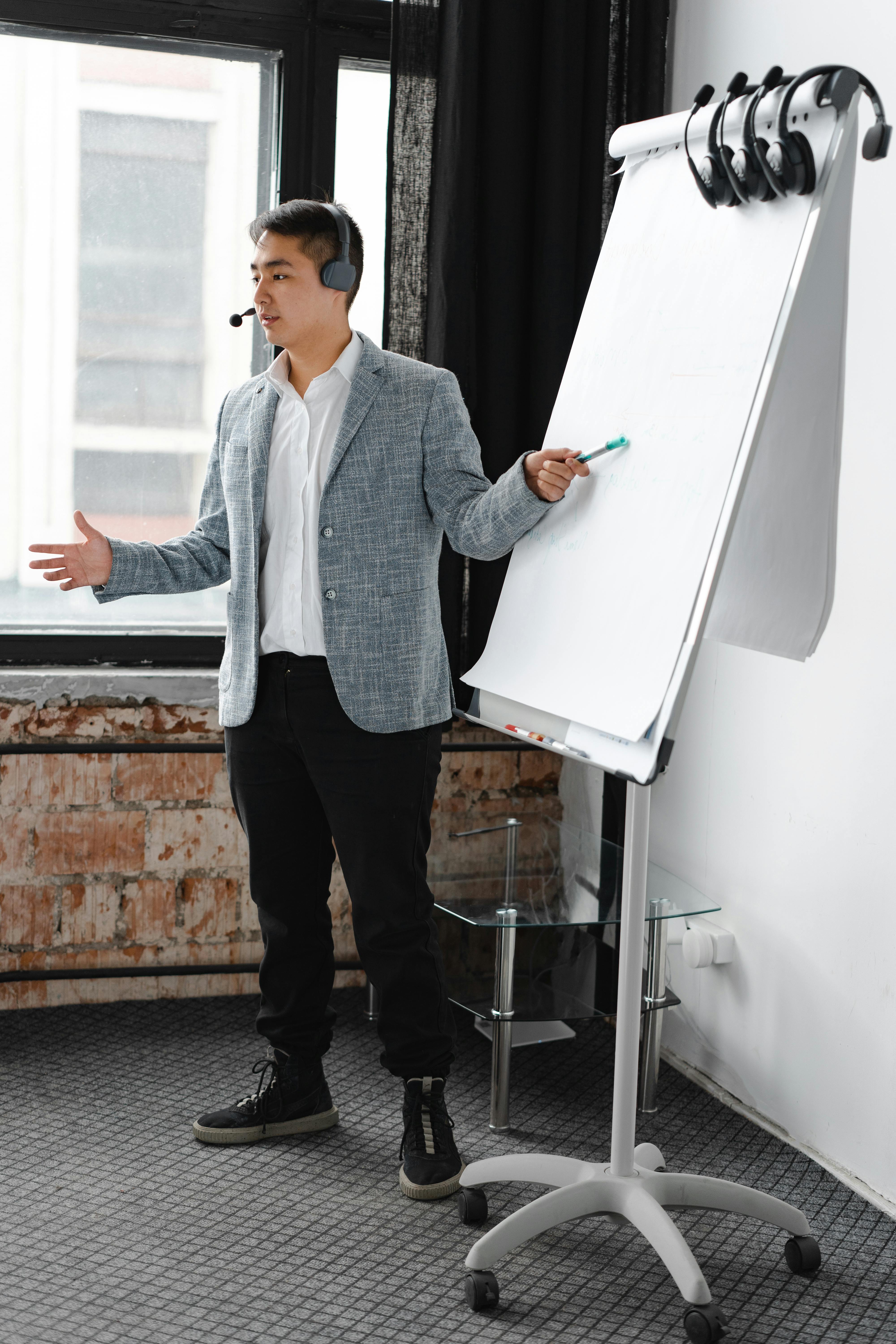 Engaging business presentation by a call center agent using a flip chart, indoors.