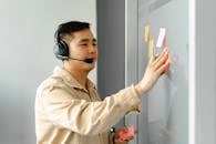 Man Wearing a Long Sleeve Holding Sticky Notes