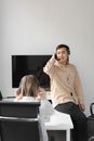 Woman in Beige Button Up Shirt Sitting on Chair