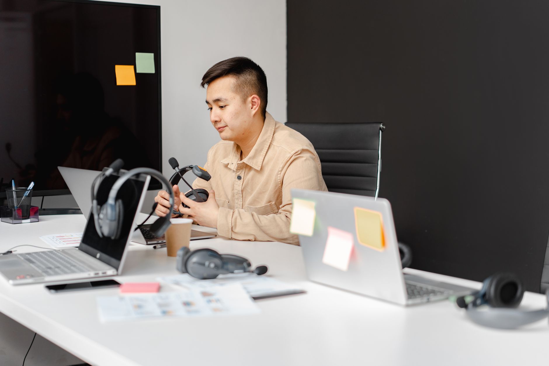 Small business owner reviewing a phased AI implementation roadmap on a laptop screen in a bright modern office with sticky notes.