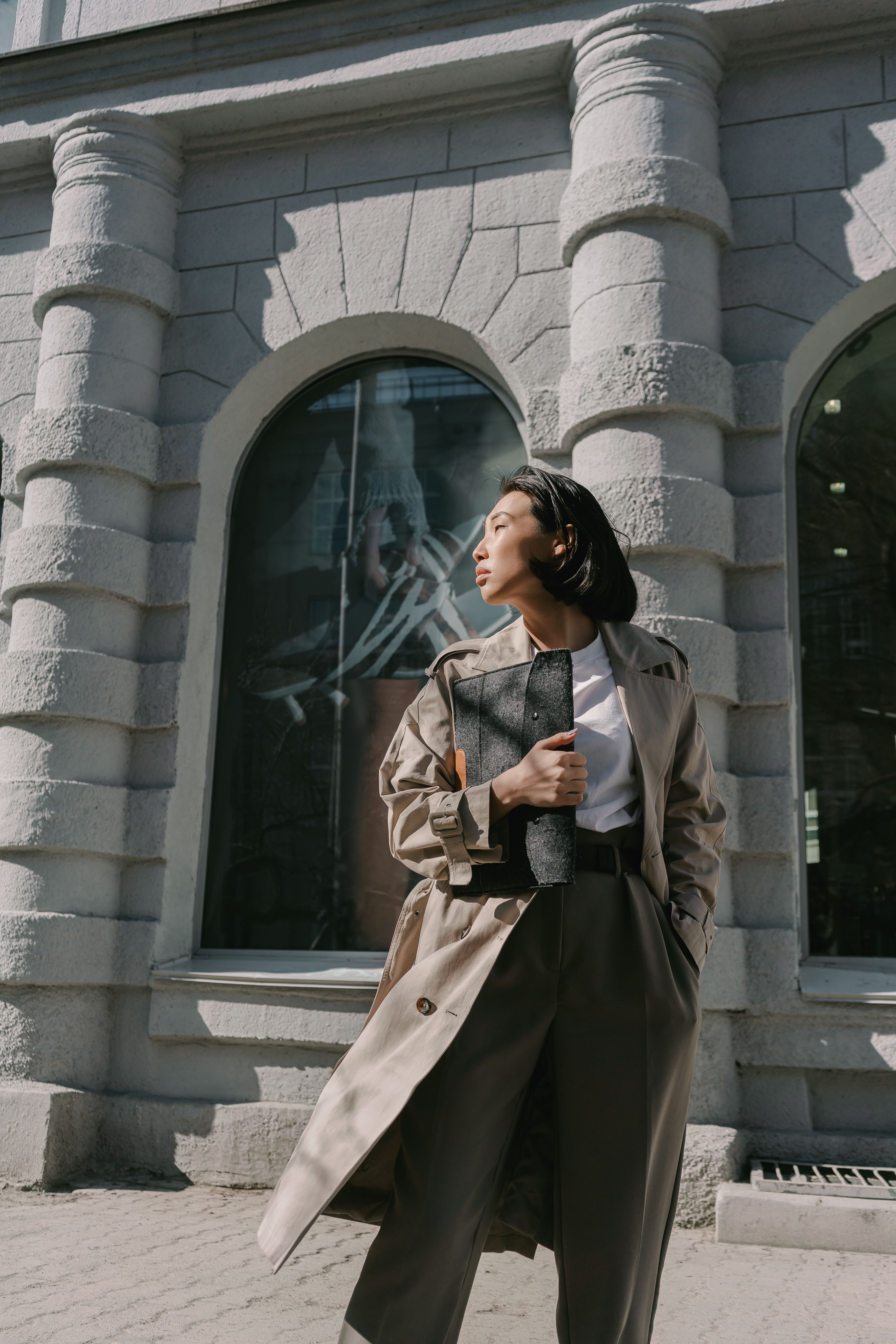 Woman in Brown Coat Standing Near Glass Window · Free Stock Photo