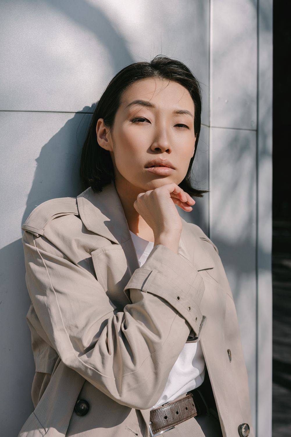 Woman in Beige Coat Leaning on Wall · Free Stock Photo