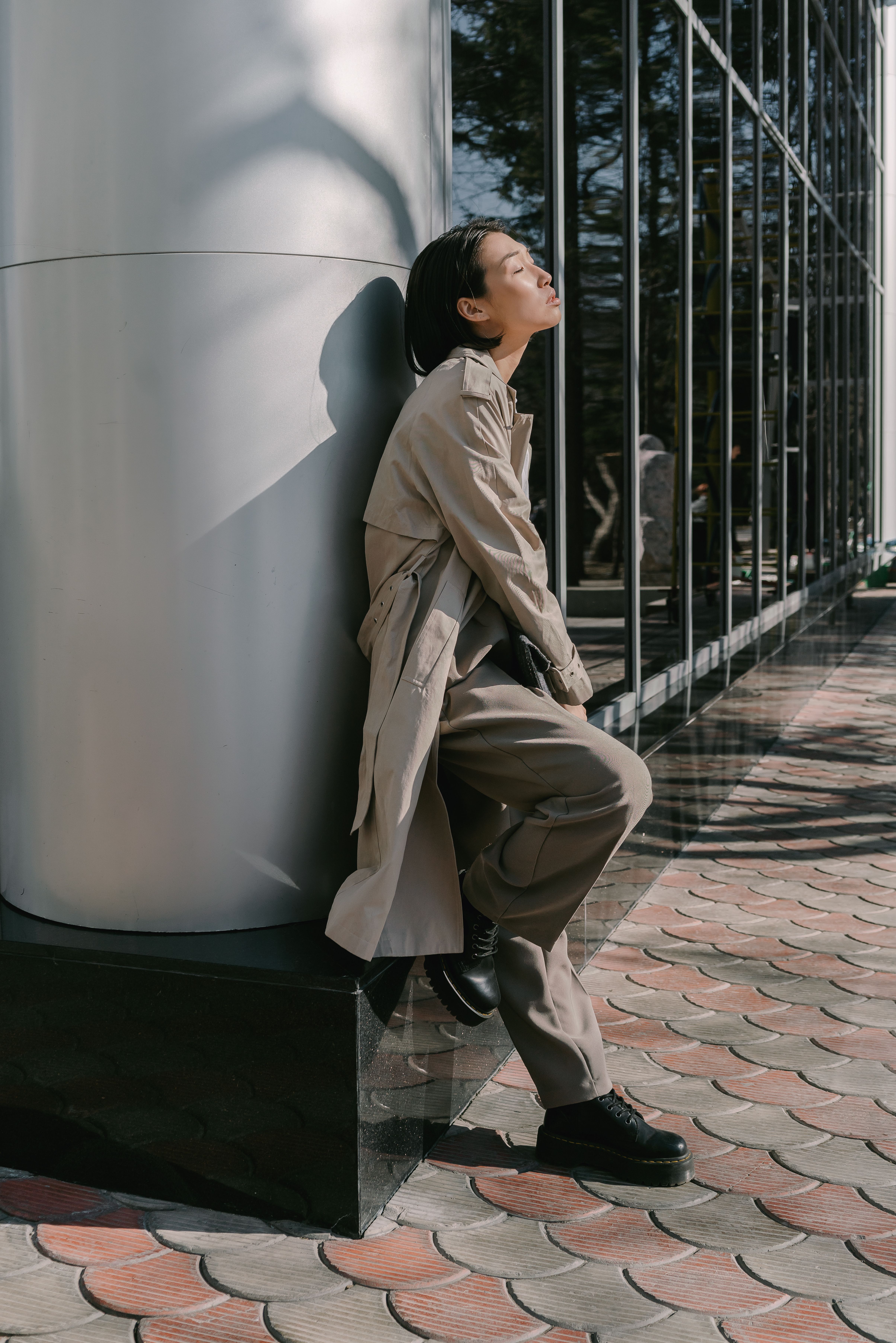 Woman in Beige Coat Leaning on Wall · Free Stock Photo