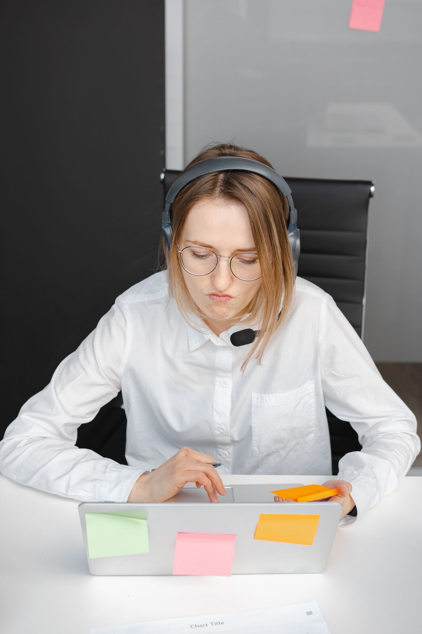 Professional support assistant working with laptop and headset