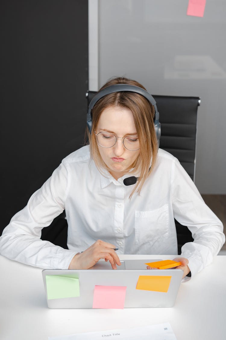 Woman Wearing Headset Using A Laptop