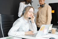 Woman in White Dress Shirt and Brown Necktie Using Macbook Air