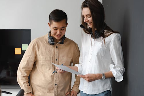 Man and Woman Looking at a Document