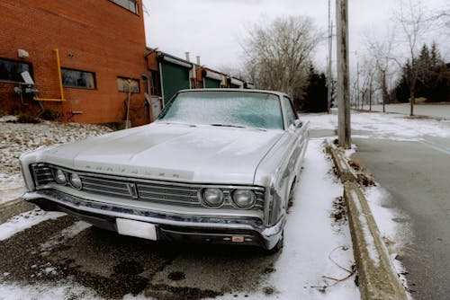 A White Vintage Car Parked Outside